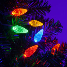 Load image into Gallery viewer, multicolor faceted christmas lights installed in a tree
