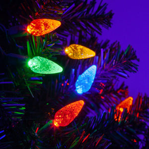 multicolor faceted christmas lights installed in a tree